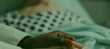 reynolds-caring-friendly-young-doctor-therapist-holding-sick-senior-patient-hand-comforting-showing-comapssion-talking-about-treatment-while-he-s-breathing-with-help-from-oxygen-mask