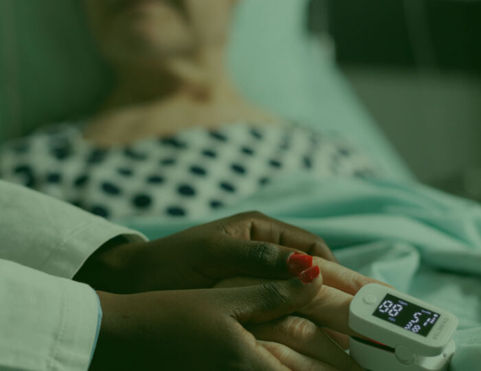 reynolds-caring-friendly-young-doctor-therapist-holding-sick-senior-patient-hand-comforting-showing-comapssion-talking-about-treatment-while-he-s-breathing-with-help-from-oxygen-mask